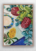Framed artwork of Australian flora with red flowers, green leaves, and a yellow flower.