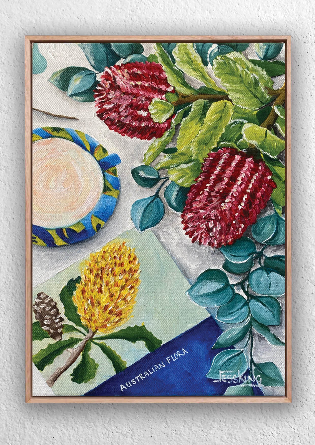 Framed artwork of Australian flora with red flowers, green leaves, and a yellow flower.