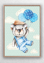Framed art print by Jess King of a bear in overalls with blue balloons on a polka dot background.